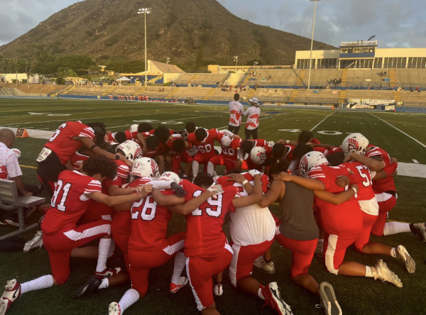 The Kalani football team huddles up to pray before their big game against east rival, Kaiser High School on Friday, Sept. 20. They ended up losing 49 to 7. 